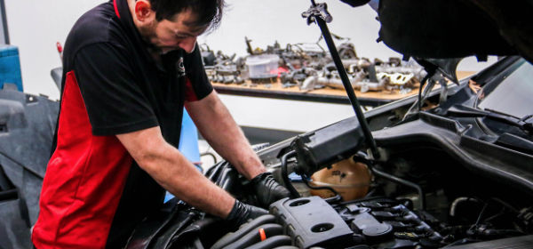 mechanice doing a service on a car service under the hood